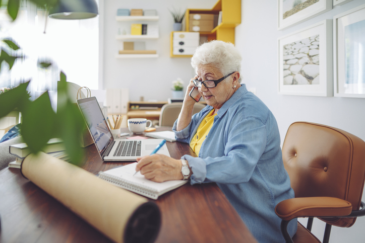 senior woman talking on her cell phone at home