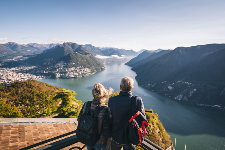 senior couple hiking above a lake