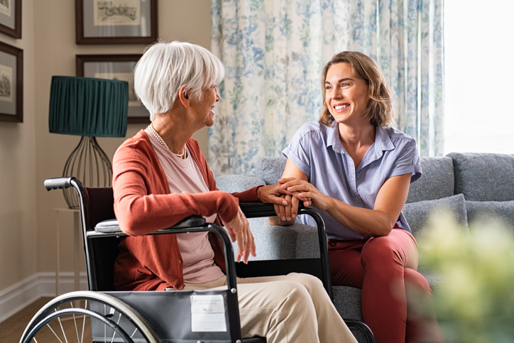 adult woman visiting her elderly mother at home